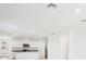 Open-concept kitchen with stainless-steel appliances and white cabinets at 667 Pennywort St, Lake Alfred, FL 33850