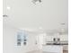 Bright open-concept kitchen with white cabinets and a granite-topped island at 667 Pennywort St, Lake Alfred, FL 33850
