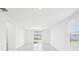 Bright living room with tile flooring, sliding glass door, and large windows at 667 Pennywort St, Lake Alfred, FL 33850