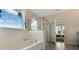Bathroom featuring a soaking tub and glass shower in a bright setting at 7213 Nottingham Reel Ct, St Cloud, FL 34773