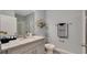 Modern bathroom with a granite countertop, a sleek glass shower, and stylish decor, offering a clean and contemporary design at 7213 Nottingham Reel Ct, St Cloud, FL 34773