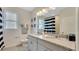 Stylish bathroom featuring double sinks with granite countertops, modern fixtures, and a coordinated black-and-white theme at 7213 Nottingham Reel Ct, St Cloud, FL 34773