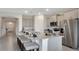Spacious kitchen featuring a granite island with bar stools, stainless steel appliances, and elegant finishes throughout the room at 7213 Nottingham Reel Ct, St Cloud, FL 34773