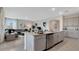 Modern kitchen with stainless steel appliances and granite countertops open to the living room at 7213 Nottingham Reel Ct, St Cloud, FL 34773