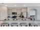 Modern kitchen featuring a granite island with seating, stainless steel appliances, and elegant decor for a stylish cooking experience at 7213 Nottingham Reel Ct, St Cloud, FL 34773