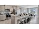 Open kitchen showcasing stainless steel appliances, a granite island with bar seating, and a seamless transition to the dining area at 7213 Nottingham Reel Ct, St Cloud, FL 34773