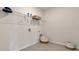 Functional laundry room with wire shelving, washer hookups and a decorative laundry basket at 7213 Nottingham Reel Ct, St Cloud, FL 34773