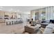 Open floorplan with kitchen island, dining room and living room area with natural lighting at 7213 Nottingham Reel Ct, St Cloud, FL 34773