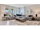 Bright living room features a modern sectional sofa, stylish decor, and large windows at 7213 Nottingham Reel Ct, St Cloud, FL 34773