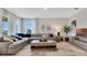 Living room with a large gray sectional sofa, neutral walls, decorative mirror and a modern rug at 7213 Nottingham Reel Ct, St Cloud, FL 34773
