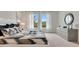 Inviting bedroom showcasing a decorative mirror and large windows with views at 7213 Nottingham Reel Ct, St Cloud, FL 34773
