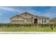 Charming single-story home with a three-car garage, manicured lawn, and stone accents at 7219 Nottingham Reel Ct, St Cloud, FL 34773