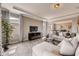 Bright living room features a modern sofa, stylish curtains, and decorative shelving for a cozy feel at 7219 Nottingham Reel Ct, St Cloud, FL 34773