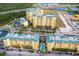 An aerial view showcasing the buildings, parking lots, and pool area of the condo community at 8101 Resort Village Dr # 31501, Orlando, FL 32821