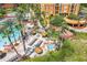 Aerial view of the resort's amenities including swimming pools, tiki bar, hot tub, playground and buildings at 8101 Resort Village Dr # 31501, Orlando, FL 32821