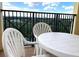 A balcony area features a white table and chairs at 8101 Resort Village Dr # 31501, Orlando, FL 32821