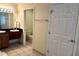 Bathroom featuring tile floors, vanity with sink and toilet in a separate room at 8101 Resort Village Dr # 31501, Orlando, FL 32821