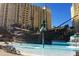 Community pool with pirate themed water feature, slide, and seating at 8101 Resort Village Dr # 31501, Orlando, FL 32821