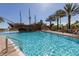 Resort-style community pool with pirate ship and lounge chairs providing a relaxing tropical atmosphere at 8101 Resort Village Dr # 31501, Orlando, FL 32821