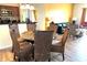 Dining area with a round glass table, wicker chairs, and view of the living room at 8101 Resort Village Dr # 31501, Orlando, FL 32821