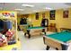 Spacious game room with multiple pool tables and a variety of arcade games at 8101 Resort Village Dr # 31501, Orlando, FL 32821