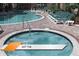 Community hot tub and pool area with lush landscaping at 8101 Resort Village Dr # 31501, Orlando, FL 32821