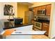 Kitchen featuring stainless steel appliances, dark countertops, and oak cabinets at 8101 Resort Village Dr # 31501, Orlando, FL 32821