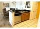 Kitchen island with a double sink, dishwasher, cabinets, and adjacent dining area at 8101 Resort Village Dr # 31501, Orlando, FL 32821