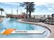 Resort swimming pool with a ship feature, lounge chairs, and palm trees at 8101 Resort Village Dr # 31501, Orlando, FL 32821