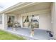Back patio with sliding glass doors and potted plants at 839 Timber Isle Dr, Orlando, FL 32828