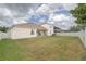 Spacious backyard with lush green grass and white vinyl fence, perfect for outdoor activities and privacy at 839 Timber Isle Dr, Orlando, FL 32828