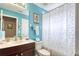 Bathroom featuring blue walls, a vanity, toilet, and shower with a floral curtain at 839 Timber Isle Dr, Orlando, FL 32828