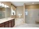 Bright bathroom with dual sink vanity, soaking tub and glass enclosed shower at 839 Timber Isle Dr, Orlando, FL 32828