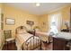 This bright bedroom features two beds, wooden floors, and warm yellow walls at 839 Timber Isle Dr, Orlando, FL 32828