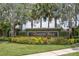Elegant Timber Isle community entrance sign surrounded by lush landscaping and colorful flowerbeds at 839 Timber Isle Dr, Orlando, FL 32828