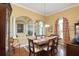 Elegant dining room with hardwood floors, decorative columns, and natural light at 839 Timber Isle Dr, Orlando, FL 32828
