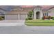 Charming home with a three car garage, arched entry, and well-manicured lawn at 839 Timber Isle Dr, Orlando, FL 32828