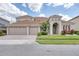 Charming home with a three car garage, arched entry, and well-manicured lawn at 839 Timber Isle Dr, Orlando, FL 32828