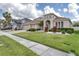 Well-maintained home with a three car garage, beautiful landscaping and a manicured lawn at 839 Timber Isle Dr, Orlando, FL 32828