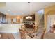 Cozy eat-in kitchen with dark wood cabinetry, tile flooring, and bar seating at 839 Timber Isle Dr, Orlando, FL 32828
