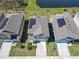An aerial view shows a house with solar panels on the roof, a well-kept lawn, and a paved driveway at 942 Jackson Ave, Davenport, FL 33837