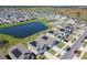 Aerial view of homes with solar panels next to a pond and neighborhood amenities at 942 Jackson Ave, Davenport, FL 33837
