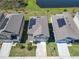 Aerial shot of suburban homes featuring solar panels and well-manicured lawns at 942 Jackson Ave, Davenport, FL 33837