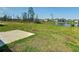 Green backyard with partial lake view at 942 Jackson Ave, Davenport, FL 33837
