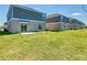 View of backyard with green lawn and row of houses at 942 Jackson Ave, Davenport, FL 33837