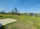 Spacious backyard featuring green grass, a lake view, with a concrete patio and a view of the community at 942 Jackson Ave, Davenport, FL 33837