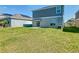 Backyard featuring a patio and green lawn at 942 Jackson Ave, Davenport, FL 33837