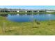 Backyard view overlooking a large pond and surrounding community homes at 942 Jackson Ave, Davenport, FL 33837