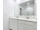 Elegant bathroom with double sinks, a large mirror, and modern fixtures at 942 Jackson Ave, Davenport, FL 33837