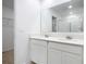 Bright bathroom featuring double vanity with white cabinets and quartz countertop at 942 Jackson Ave, Davenport, FL 33837
